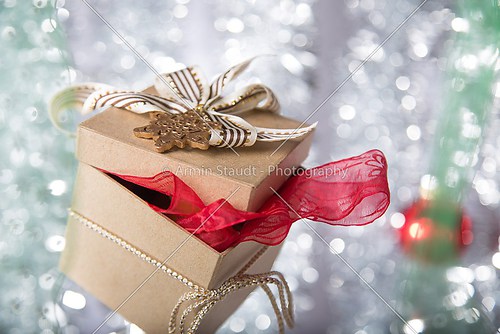 gift box with golden star, bow, ribbon and christmas ball