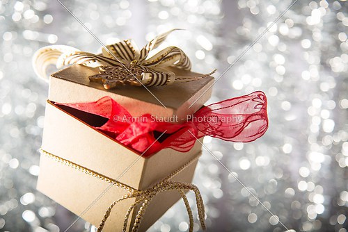 christmas gift box with golden star, bow and ribbon