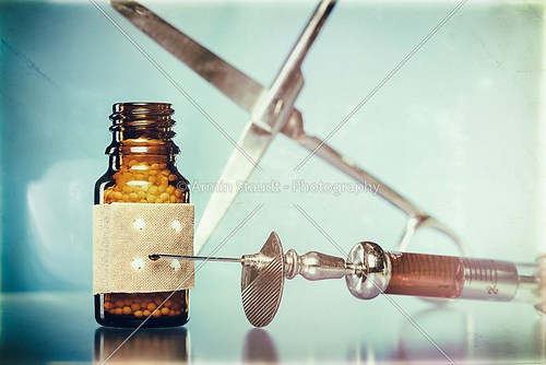 vintage still life with homeopathy globules. syringe with blood,