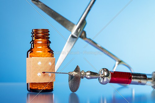 still life with homeopathy globules. syringe with blood,  plaste