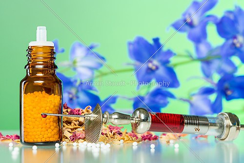 still life with homeopathy globule, syringe with blood, some spi