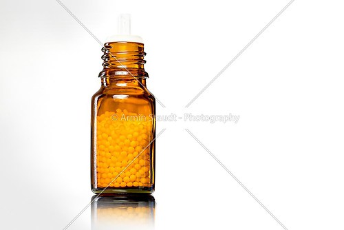 single bottles with homeopathy globules,white white background
