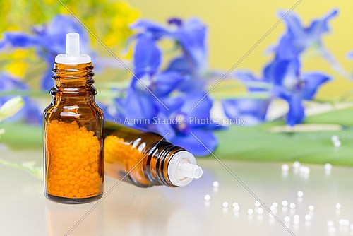 two bottles with homeopathy globules and flowers, with white ref