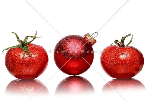 still life with two tomatoes and one red christmas ball, isolate