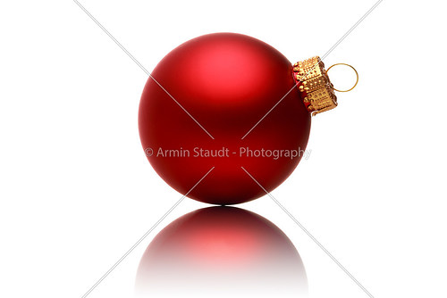 close up of a red christmas ball with reflection, isolated on wh
