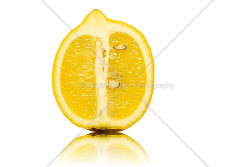 close up of a half of a lemon, isolated on white