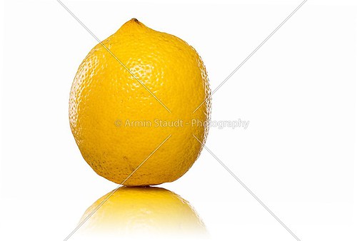 yellow lemon standing with reflection, isolated on white