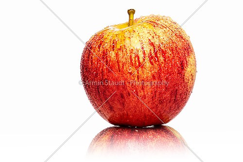 red fresh apple with water drops, isolated on white