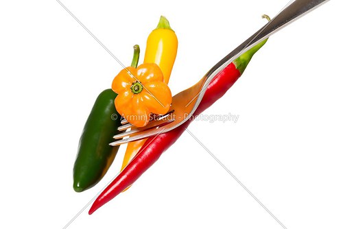 some hot chili on a fork, isolated on white