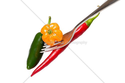 some hot chili on a fork, isolated on white