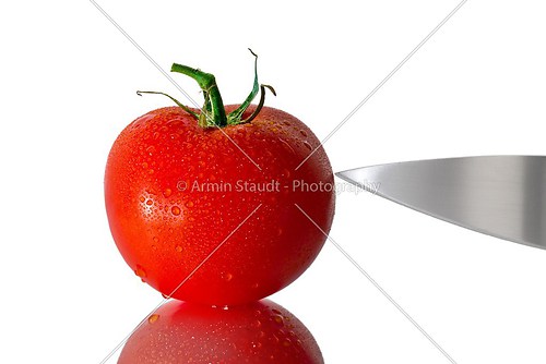 wet tomato with knife