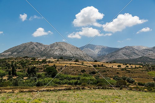 greek landscape with meadow, mountain and blue sky