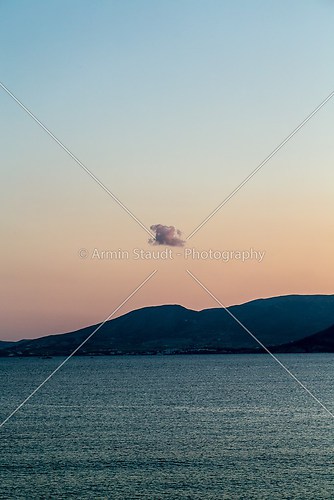 lonely cloud over an island mountain, sunset