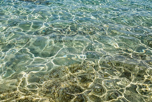 clear ocean water surface with reflections for backgrounds