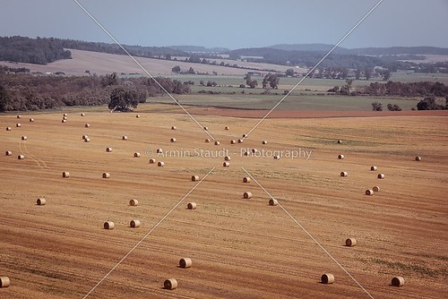 harvest field with bale of straw, vintage color filter