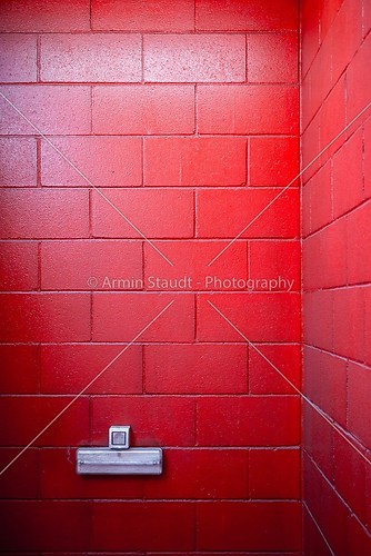 a very red painted brick wall with socket for backgrounds