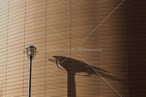 shadow of a street light on a patterned wall