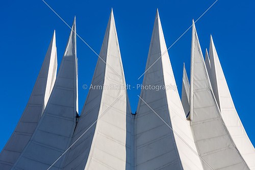 white futuristic roof with spikes, isolated on blue sky