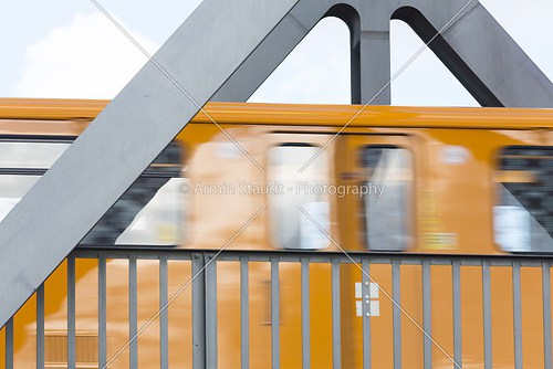 fast moving yellow berlin subway on a bridge