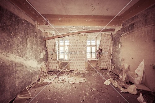 ruinous empty room with old wallpapers and sepia color filter