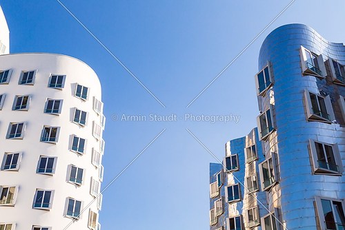 white and metallic houses with blue windows, modern architecture