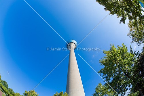 tv tower with some trees in front isolated on blue sky, duesseld