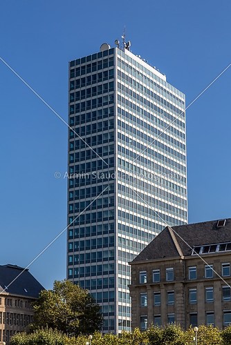 shoot of an office building and old buildings in front, with blu