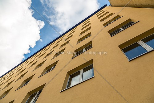 extreme perspective of a yellow house wall with blue sky