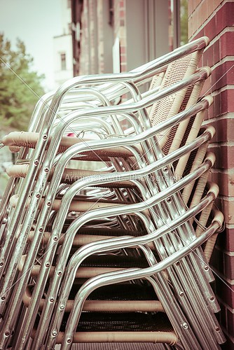 a stack of aluminum chairs from a restaurant