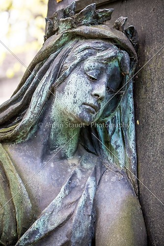 bronze sculpture of a sad woman
