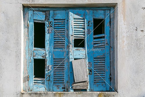 very old and damaged blue shutter