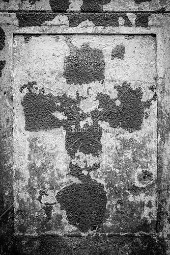 faded cross  on an old parget wall