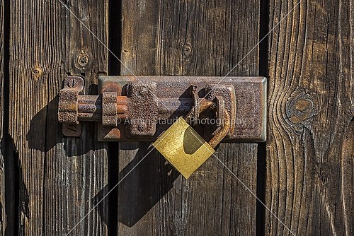Old key lock on wooden door 