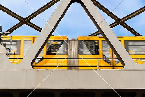 yellow moving tram on a bridge in berlin