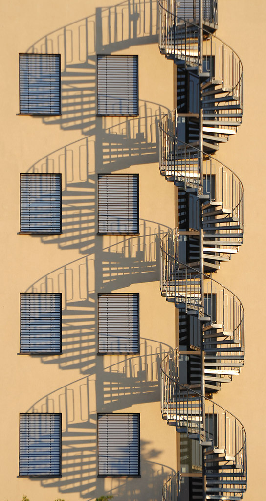 Spiral Staircase (Spiral Staircase) | Symmetrical by repetition in warm sunlight of a spiral staircase | spiral, staircase, shadow, light, sunny, house, architecture, symmetrical