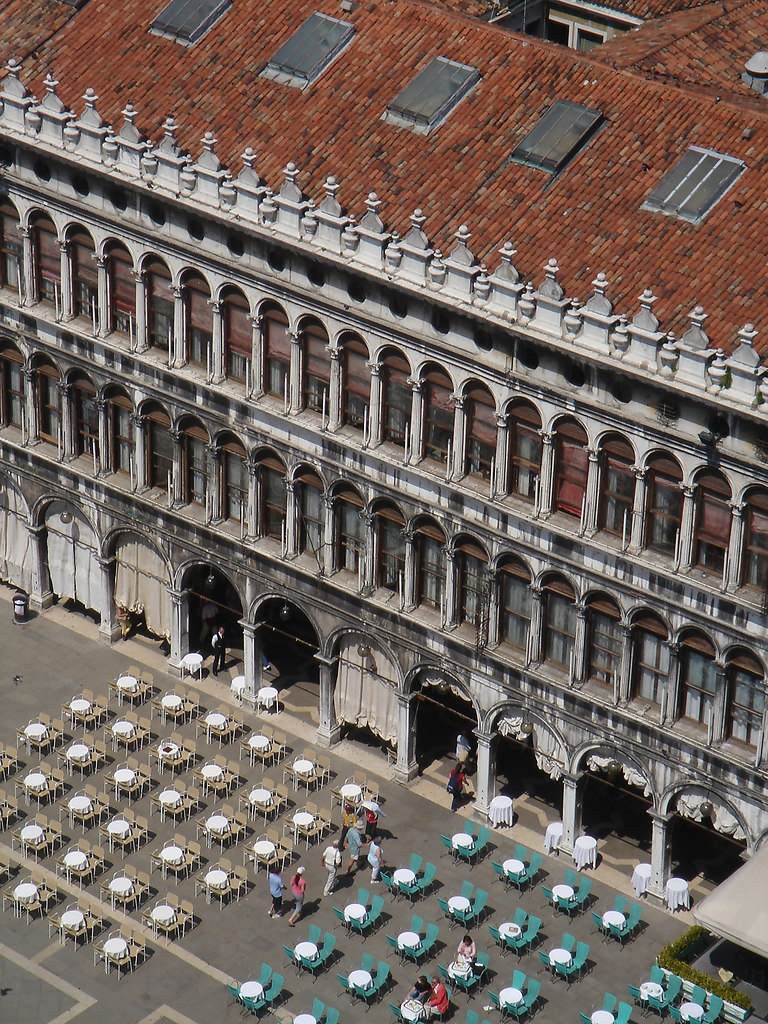 St. Mark's Square (Venice) | High angle view of St. Mark’s Square in Venice | Italy, Venice, St. Mark’s Square, high angle view, in a row, travel destination, parasols, roof windows, columns, pillars, people