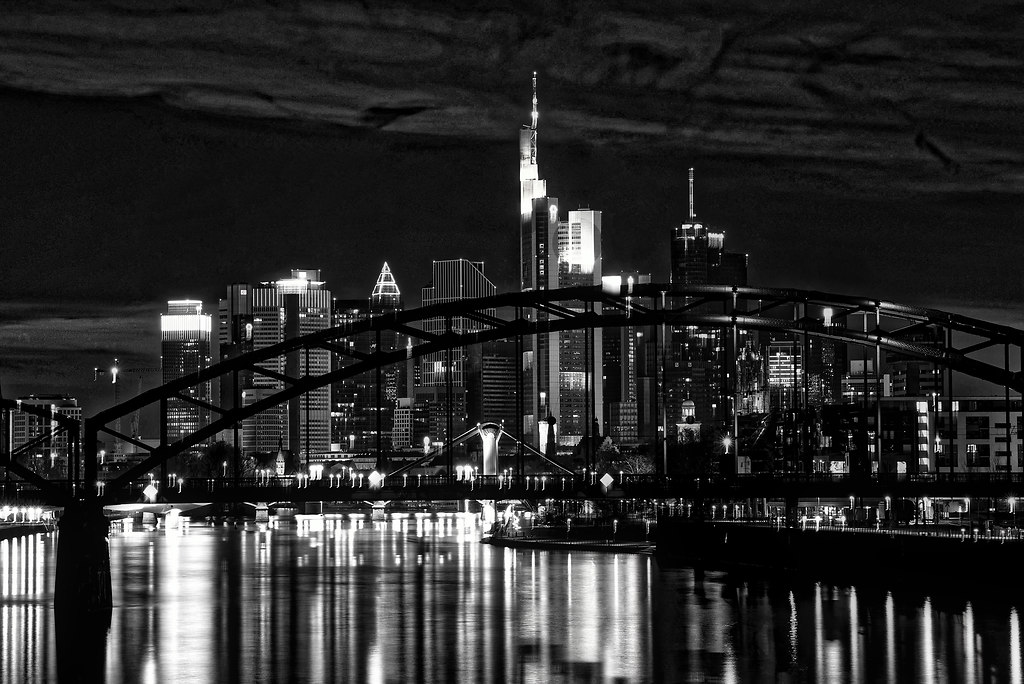 Frankfurt Skyline (Skyline) | Frankfurt Skyline with river reflections black and white modern | monochrome, city, architecture, reflection, bridge, travel, building, skyscrapers, water, river, urban, light, black and white, horizontal, modern